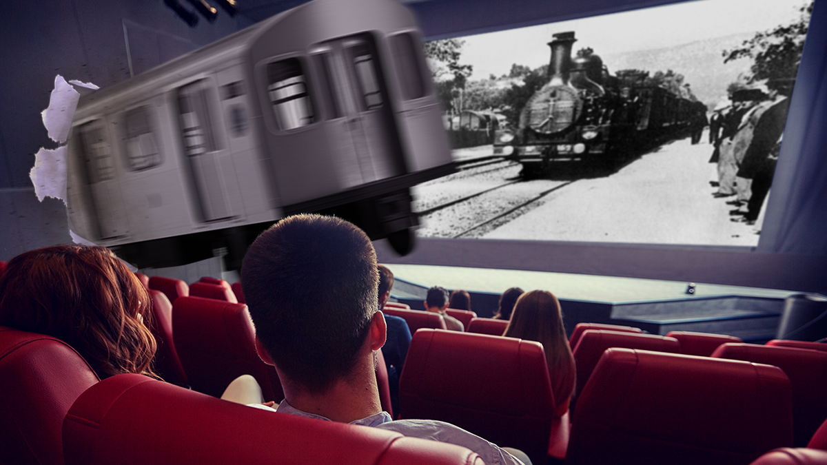 A subway train bursting through the side of a movie theater, as the theater's screen displays 1895 documentary film L'arrivée d'un train en gare de La Ciotat.