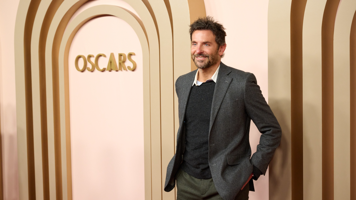 Bradley Cooper in front of an Oscars® logo.