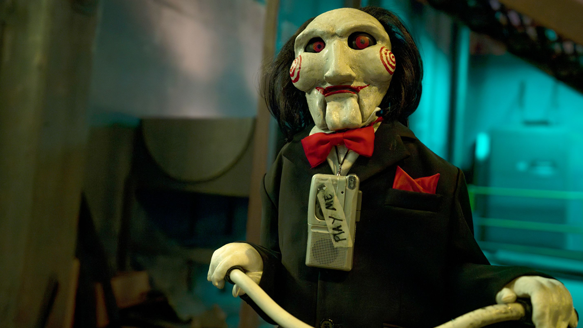 Jigsaw’s Girlfriend Digs for Engagement Ring Embedded in Chest of Chained-Up Friend